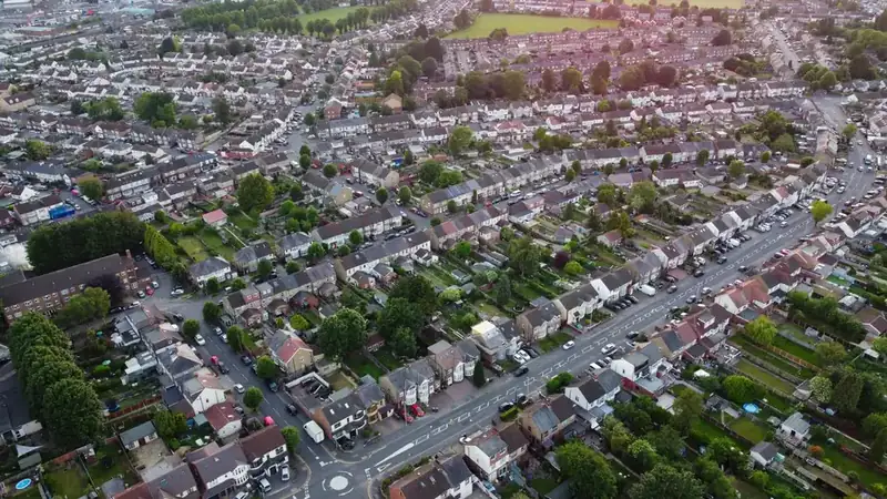 Aerial view of rows of semi detached houses and their pitched roofs on a suburban estate