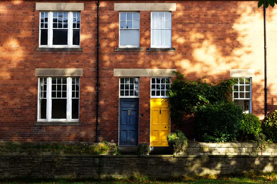 Front doors of a red brick terrace of the kind doorstep roofing callers work in Mansfield
