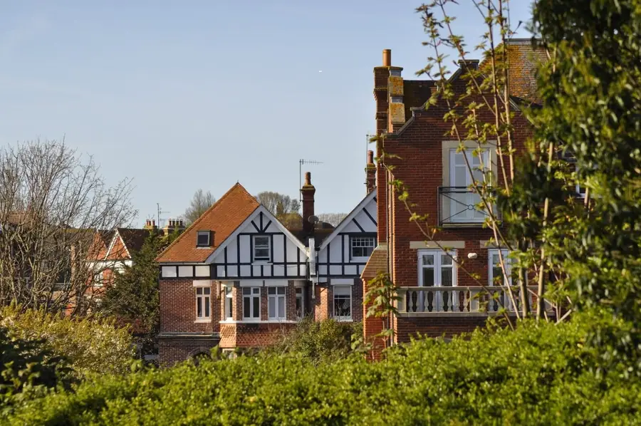 Clean tiled roofs and chimneys on English brick homes of the sort found across Mansfield