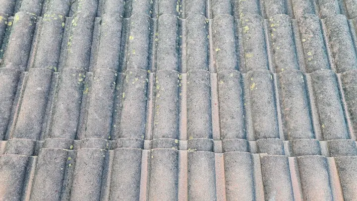 Close-up of the granular surface on weathered concrete interlocking roof tiles in Mansfield