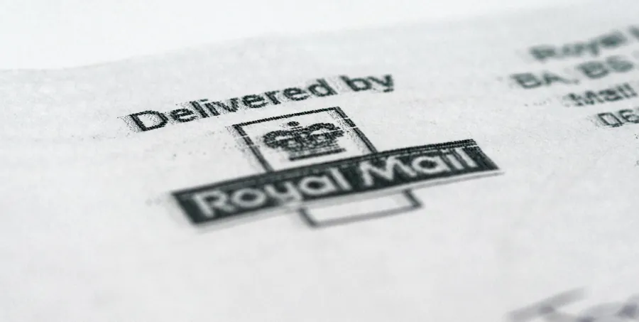 Close-up of a Royal Mail delivery mark on an envelope, the way a registered roofing guarantee certificate should reach you after the job