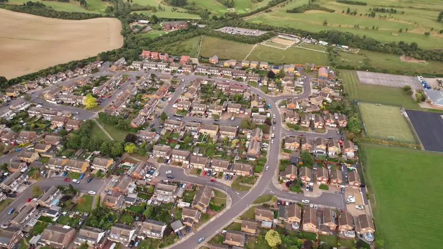 Aerial view over rows of housing rooftops in a residential district