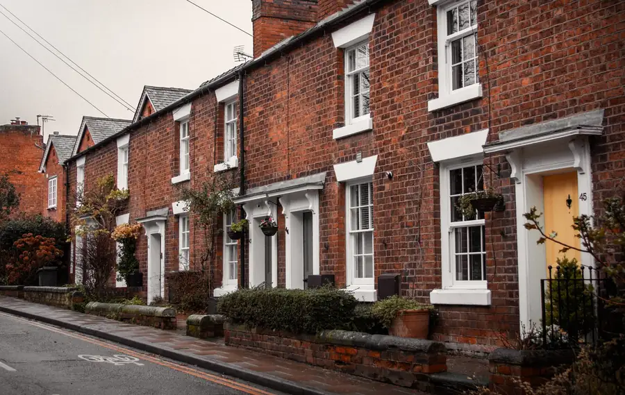 Red brick terraced houses with tiled roofs on an English street, typical of Mansfield housing