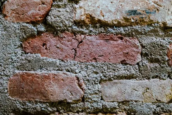 Hard cement mortar spread over soft old brick, a common bad repair on Mansfield chimneys