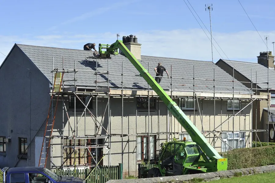 Scaffolding around a semi-detached house during a re-roof, showing the access costs behind roof work in Warsop, Shirebrook and Clipstone