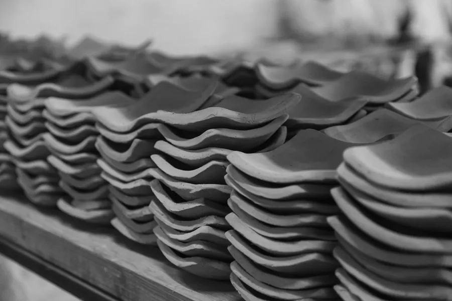 Stacks of new clay roof tiles laid out ready for a roofing job