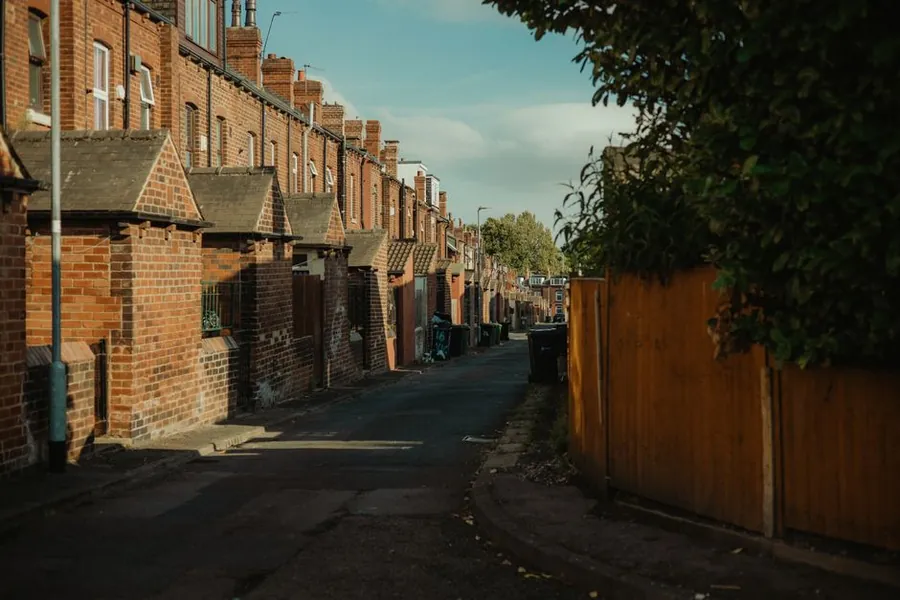Back street of Victorian red brick terraced houses with slate roofs and brick chimneys