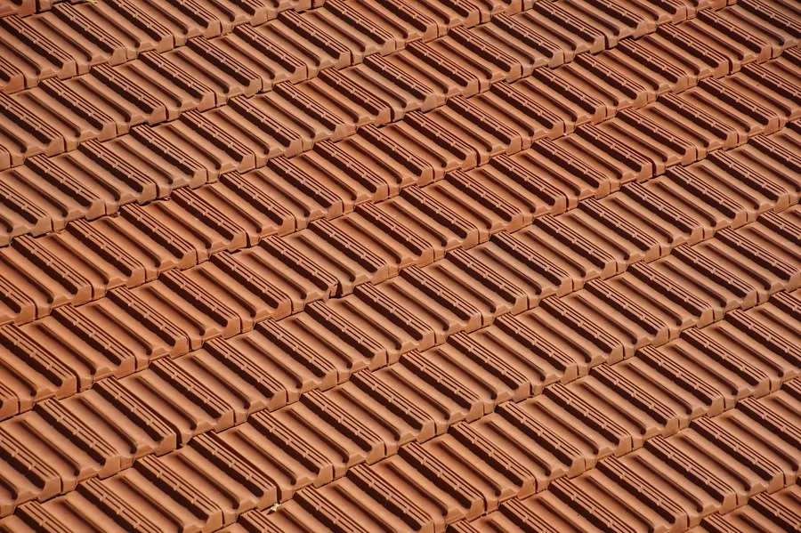 Close view of weathered clay roof tiles showing surface wear