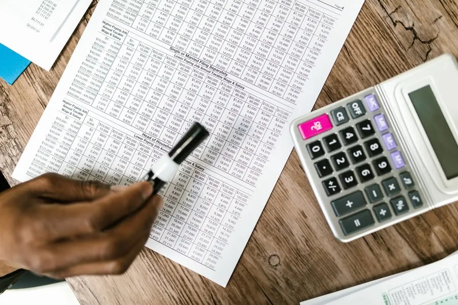 Working through claim figures and paperwork with a calculator