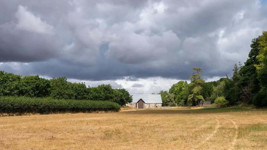Dark storm front moving in over housing in the Nottinghamshire countryside