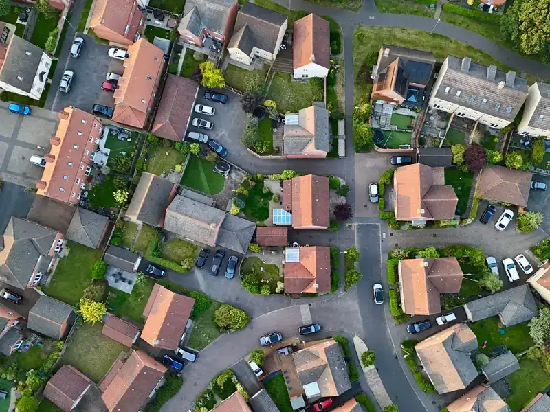 Aerial view of a British housing estate with tiled roofs, gardens and cul-de-sacs, the kind of layout found across Clipstone's newer streets