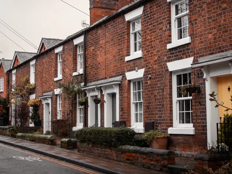Row of red brick terraced houses with slate roofs and chimneys, similar to the colliery-era streets around Mansfield Woodhouse