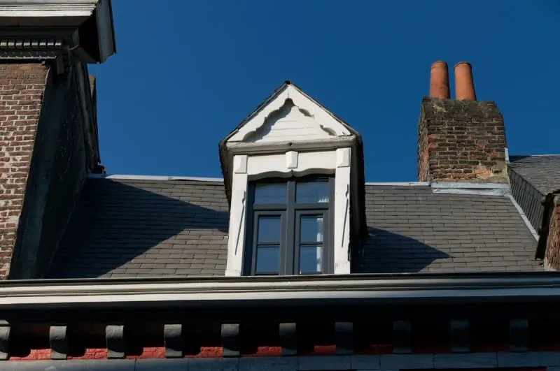 Slate roof, dormer and brick chimney above the eaves of a Mansfield house