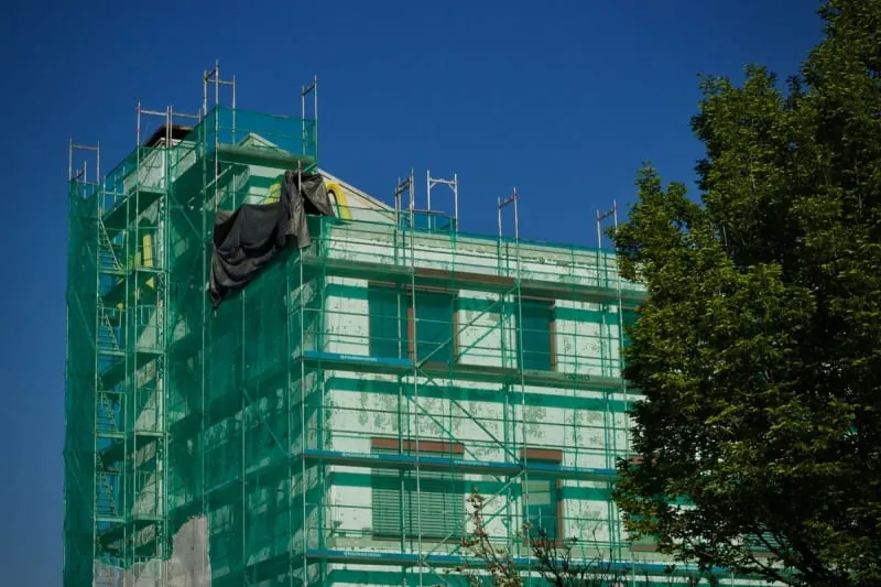 Scaffolding and netting around a Mansfield house during roofline replacement